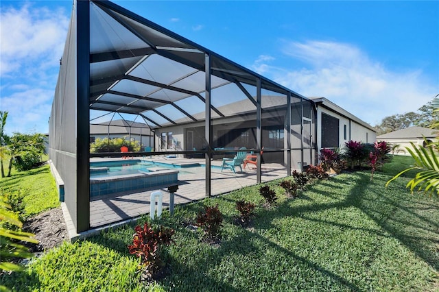 pool with a patio, a lawn, and glass enclosure