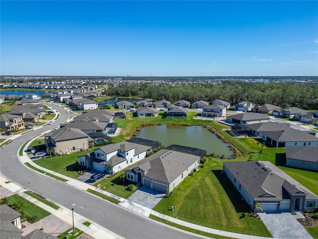 drone / aerial view featuring a residential view and a water view