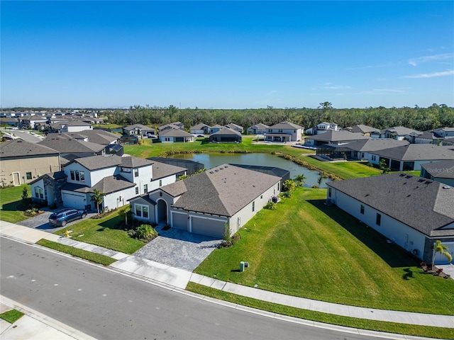 birds eye view of property featuring a water view and a residential view