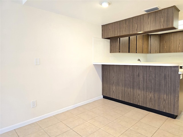 kitchen with decorative backsplash and light tile patterned floors