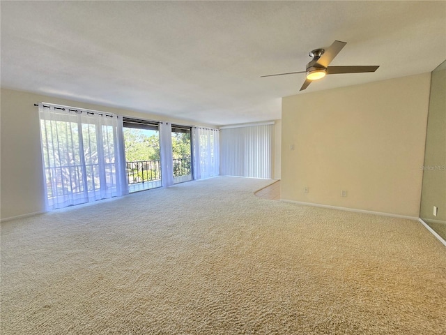 carpeted spare room with ceiling fan