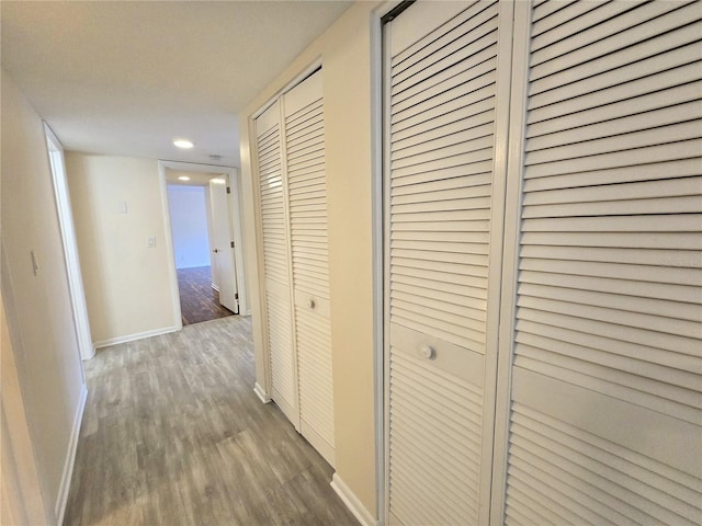 corridor with hardwood / wood-style floors