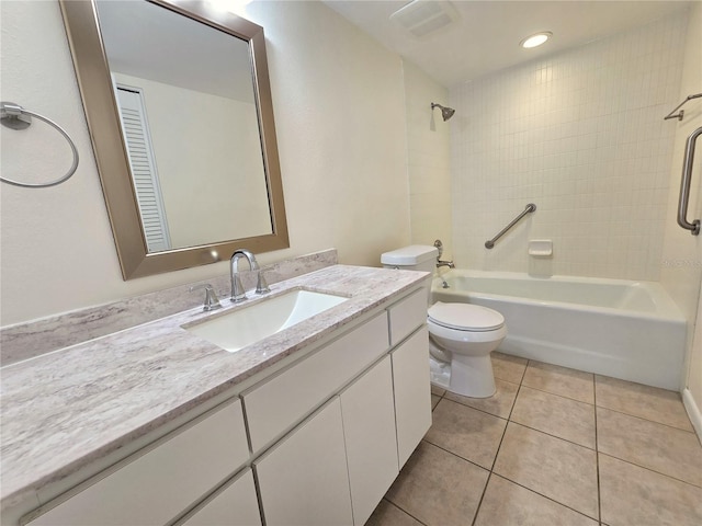 full bathroom with tile patterned floors, vanity, tiled shower / bath combo, and toilet