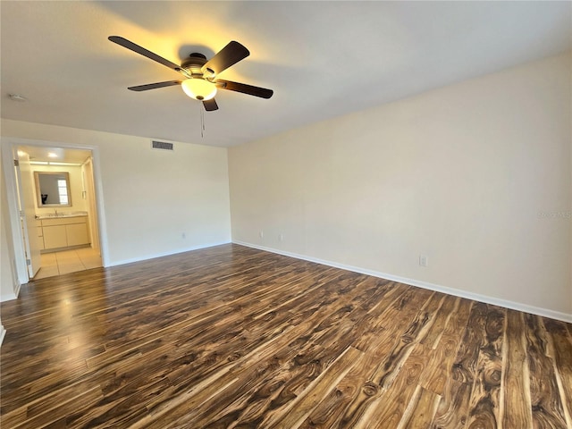 unfurnished room with ceiling fan and hardwood / wood-style flooring