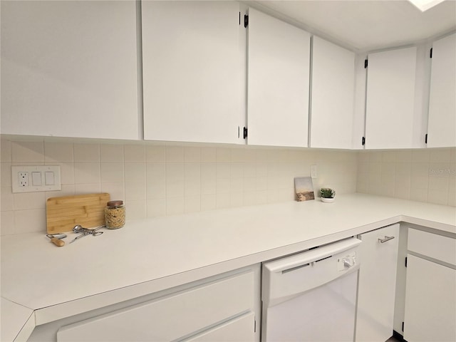 3031 Countryside Blvd Unit 35C, Clearwater, FL 33761 - kitchen with white dishwasher, light countertops, white cabinets, and decorative backsplash