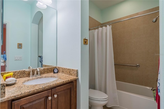 full bathroom featuring shower / bath combination with curtain, vanity, and toilet