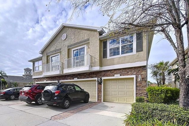 multi unit property featuring a garage and a balcony