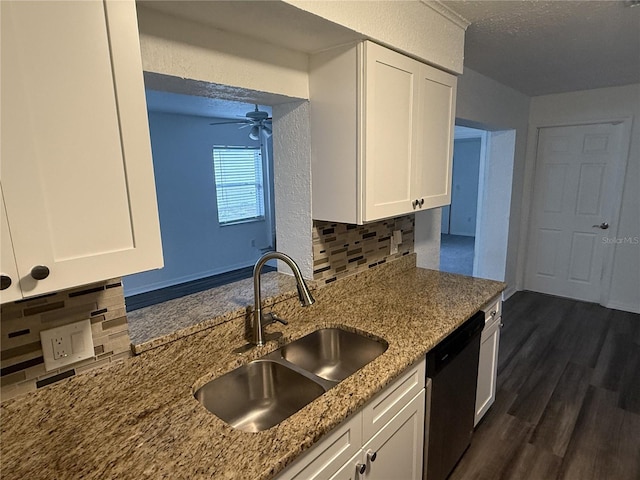 kitchen featuring a ceiling fan, white cabinets, a sink, light stone countertops, and dishwasher