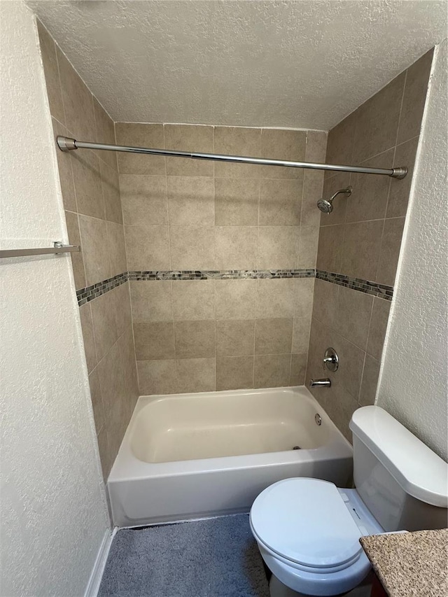 full bath featuring toilet, bathing tub / shower combination, a textured ceiling, and a textured wall