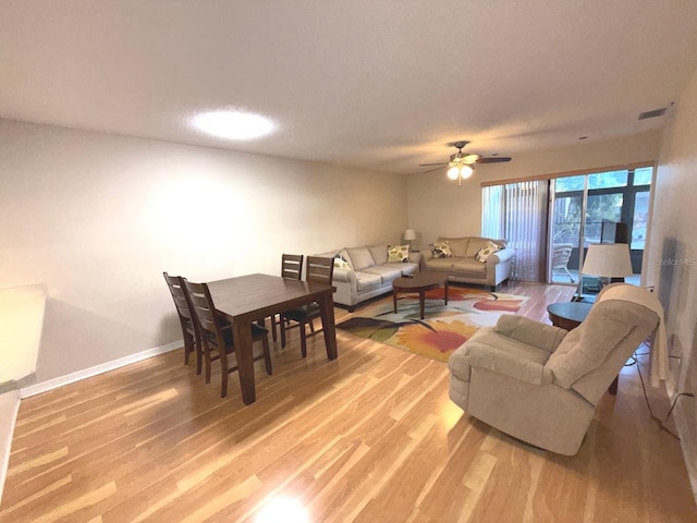 living room featuring hardwood / wood-style floors and ceiling fan