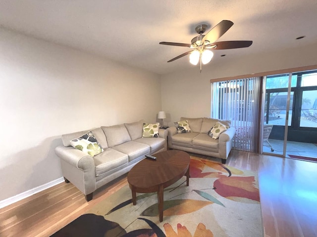 living room with wood-type flooring and ceiling fan