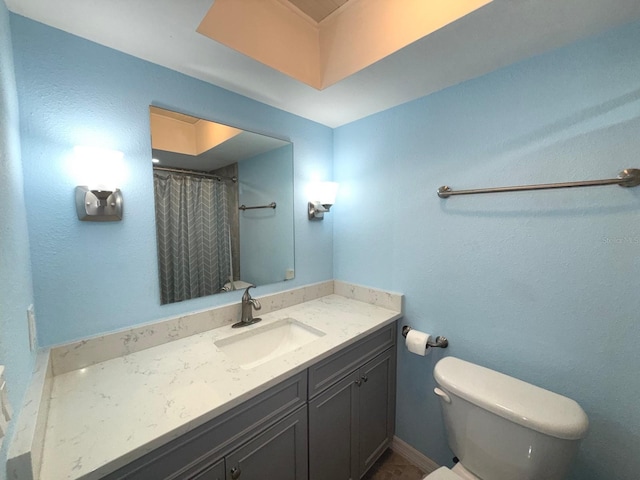 bathroom with vanity, toilet, and curtained shower