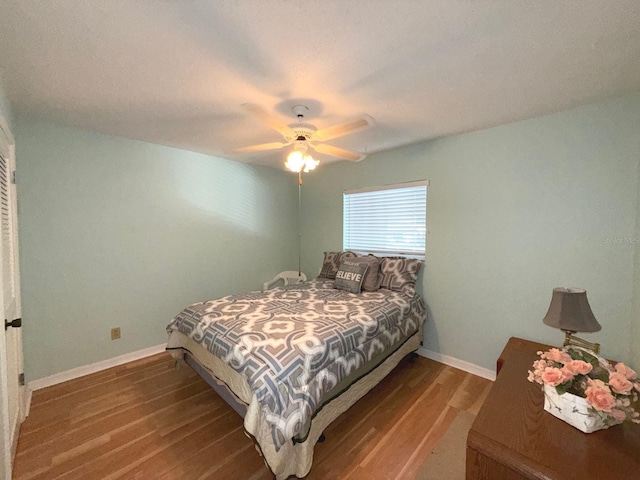 bedroom with ceiling fan and dark hardwood / wood-style floors