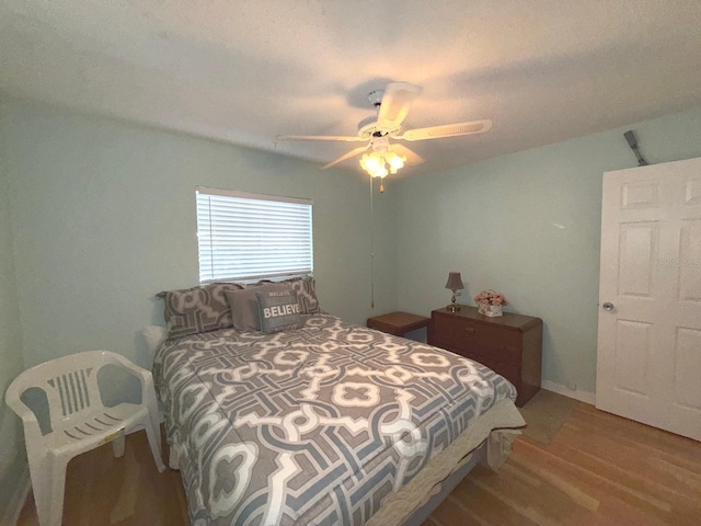 bedroom with wood-type flooring and ceiling fan