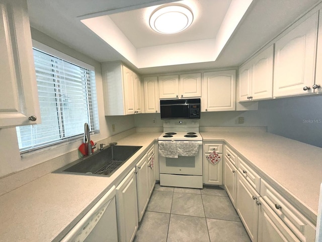 kitchen with a tray ceiling, sink, white cabinets, and white appliances