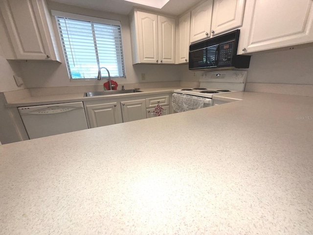 kitchen with white cabinets, white appliances, and sink