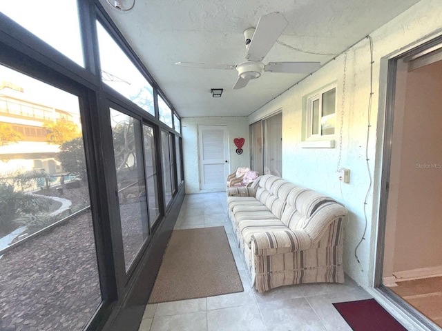 sunroom featuring ceiling fan