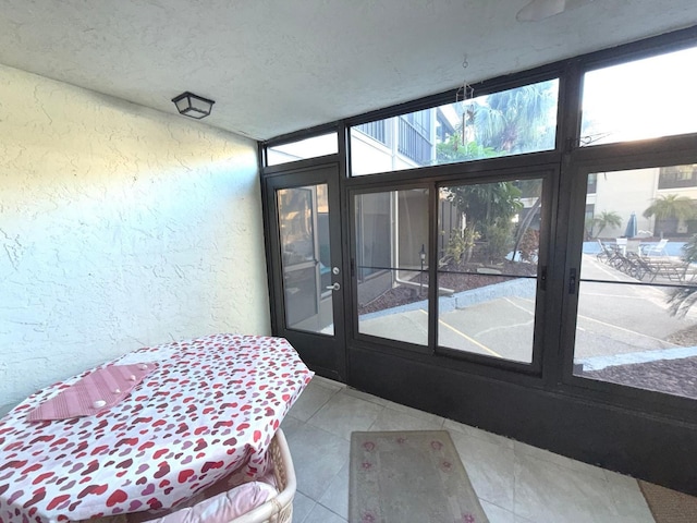 interior space featuring light tile patterned floors and a textured ceiling