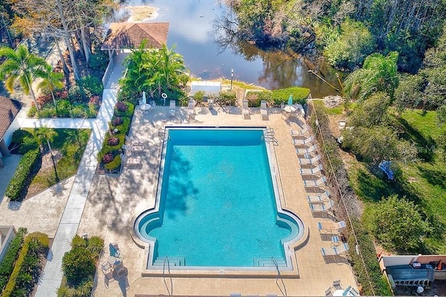 view of swimming pool with a water view and a patio