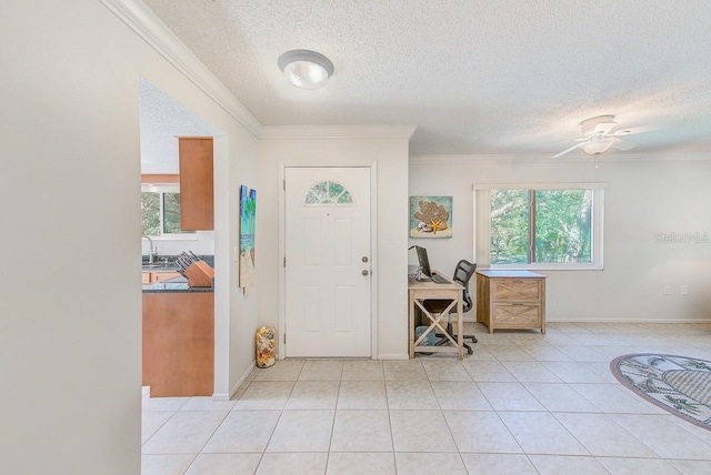 entrance foyer featuring crown molding, a healthy amount of sunlight, a textured ceiling, and ceiling fan