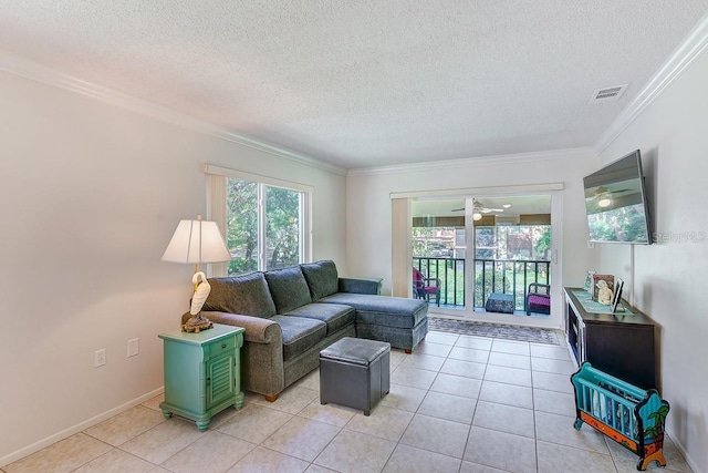 living room featuring light tile patterned floors, crown molding, a textured ceiling, and ceiling fan