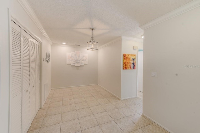 hall with crown molding, a textured ceiling, and light tile patterned floors