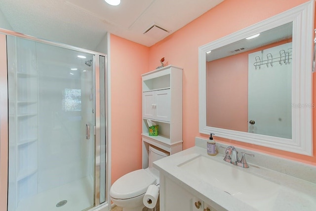 bathroom featuring a shower with door, vanity, and toilet