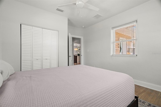 bedroom with hardwood / wood-style floors, a closet, and ceiling fan