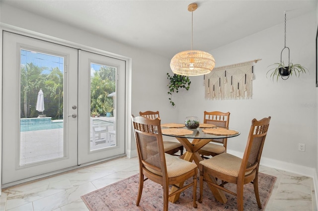 dining room with french doors and a chandelier