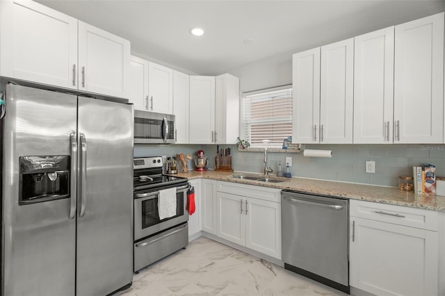 kitchen with white cabinetry, sink, and appliances with stainless steel finishes