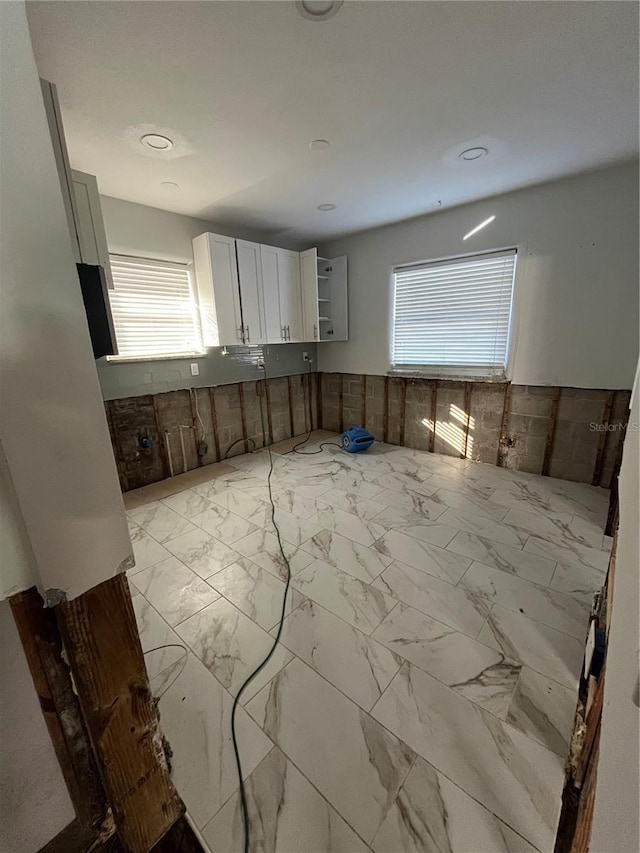 kitchen featuring white cabinets and a healthy amount of sunlight