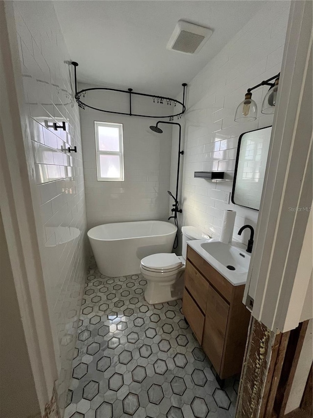 full bathroom featuring vanity, toilet, and shower / washtub combination