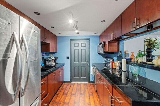 kitchen with appliances with stainless steel finishes and light wood-type flooring