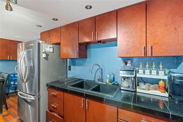 kitchen featuring hardwood / wood-style flooring, stainless steel refrigerator, and sink