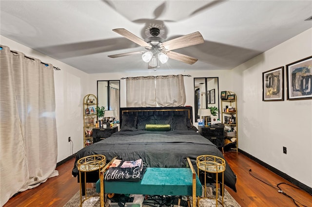 bedroom with ceiling fan and dark wood-type flooring