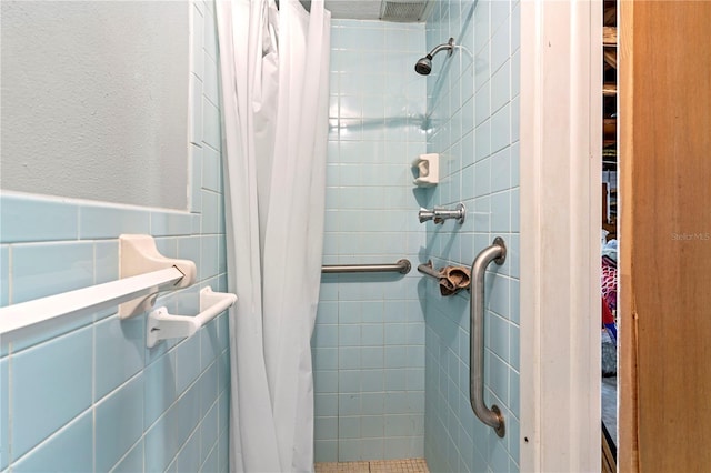 bathroom featuring a shower with curtain and tile walls