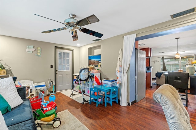 living room with ceiling fan and dark hardwood / wood-style floors