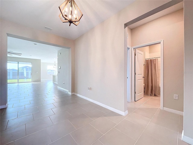 interior space with ceiling fan with notable chandelier