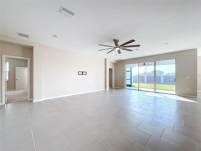 spare room with light tile patterned floors and ceiling fan