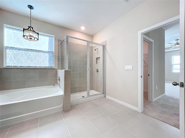 bathroom with tile patterned flooring, separate shower and tub, and ceiling fan