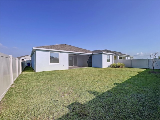 rear view of house with a yard