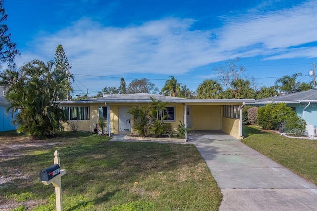 ranch-style house featuring a front yard and a carport