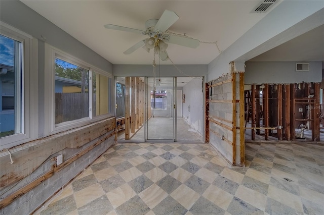 interior space with ceiling fan