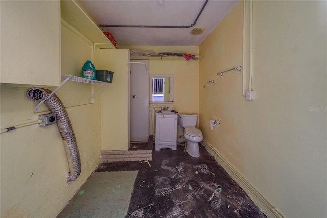 bathroom featuring concrete floors and toilet