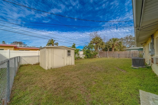 view of yard featuring a shed and central AC unit