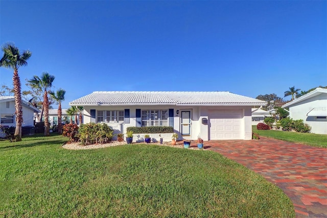 ranch-style house with a garage and a front lawn