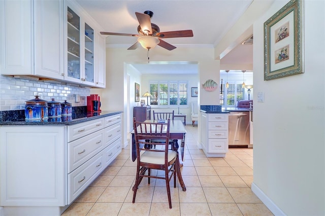 kitchen with decorative backsplash, dishwasher, white cabinets, and light tile patterned flooring