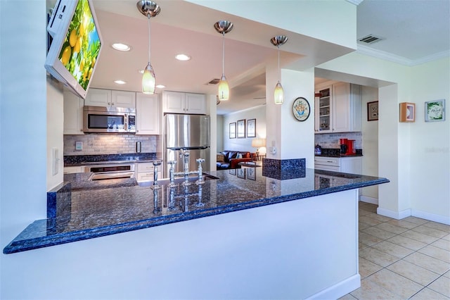 kitchen featuring kitchen peninsula, stainless steel appliances, light tile patterned floors, white cabinetry, and hanging light fixtures