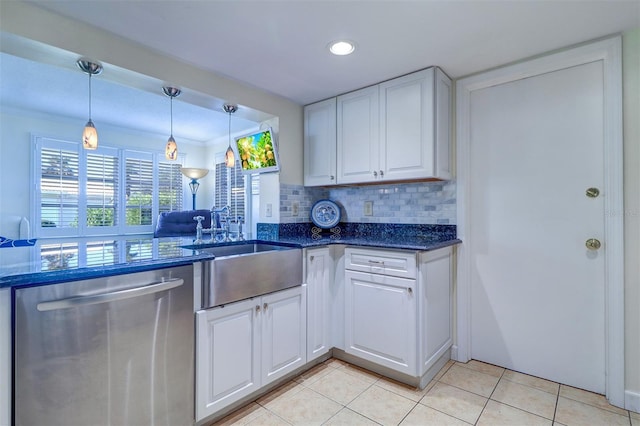 kitchen with stainless steel dishwasher, white cabinets, sink, and tasteful backsplash