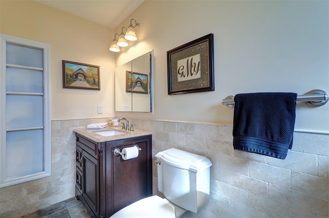 bathroom featuring vanity and tile walls